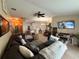 Spacious living room featuring a large sectional couch and a ceiling fan at 13443 Graham Yarden Dr, Riverview, FL 33579