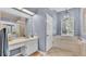 Bright bathroom featuring a vanity with sink and soaking tub under a window at 2332 Timbergrove Dr, Valrico, FL 33596
