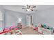 Bright bedroom with a ceiling fan, light blue walls, and light laminate flooring at 2332 Timbergrove Dr, Valrico, FL 33596