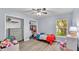 Bedroom featuring a window, two closets, light laminate flooring, and light blue walls at 2332 Timbergrove Dr, Valrico, FL 33596