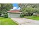 Charming home exterior with mature landscaping, a well-maintained lawn, and two car garage at 2332 Timbergrove Dr, Valrico, FL 33596
