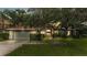 Well-maintained home featuring a two-car garage, manicured lawn, lush landscaping, and a welcoming entryway at 2332 Timbergrove Dr, Valrico, FL 33596