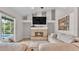Cozy living room with a stone fireplace, large windows, and view to the pool at 2332 Timbergrove Dr, Valrico, FL 33596