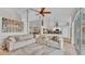 Spacious living room featuring a large sectional sofa, vaulted ceilings, and view of the open kitchen at 2332 Timbergrove Dr, Valrico, FL 33596