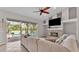 Comfortable living room featuring a stone fireplace, and access to a screened patio with a pool view at 2332 Timbergrove Dr, Valrico, FL 33596