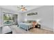 The main bedroom includes a ceiling fan, a window, and sliding glass doors offering access and views to the pool at 2332 Timbergrove Dr, Valrico, FL 33596