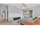 View of main bedroom including a ceiling fan, window, and sliding glass doors with access and views to the pool at 2332 Timbergrove Dr, Valrico, FL 33596