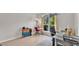 Bright office with a large window, neutral walls, modern desk, and a colorful rolling storage cart at 2332 Timbergrove Dr, Valrico, FL 33596