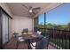 Relaxing screened balcony features a table setting for outdoor dining with views of the surrounding greenery at 23465 Harborview Rd # 223, Punta Gorda, FL 33980