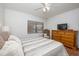 Comfortable bedroom with wood floors, dresser, and large window for natural light at 23465 Harborview Rd # 223, Punta Gorda, FL 33980