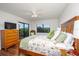 Comfortable bedroom featuring a ceiling fan, wood floors, and access to a private balcony at 23465 Harborview Rd # 223, Punta Gorda, FL 33980