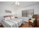 Cozy bedroom with hardwood floors, wicker chair, natural light from window, and warm neutral tones at 23465 Harborview Rd # 223, Punta Gorda, FL 33980