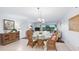 Bright dining area with a glass-top table, wicker chairs, and open view to the living room at 23465 Harborview Rd # 223, Punta Gorda, FL 33980