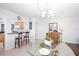 Bright dining area with pass through to the kitchen features a glass table and seating for four at 23465 Harborview Rd # 223, Punta Gorda, FL 33980