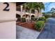 Exterior view of a building with well-maintained landscaping and a welcoming entrance at 23465 Harborview Rd # 223, Punta Gorda, FL 33980