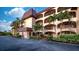 Multi-story condo building with lush landscaping and multiple balconies providing outdoor living at 23465 Harborview Rd # 223, Punta Gorda, FL 33980