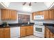 Bright kitchen with a stainless steel sink, modern appliances, and wood cabinetry at 23465 Harborview Rd # 223, Punta Gorda, FL 33980