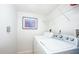 Efficient laundry room featuring a modern washer and dryer, and convenient shelving at 23465 Harborview Rd # 223, Punta Gorda, FL 33980