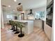 Bright kitchen featuring modern appliances, a center island, and stylish green bar stools at 320 Palm Ne Is, Clearwater Beach, FL 33767