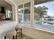 Bright living room featuring a large window with pool and waterway views at 320 Palm Ne Is, Clearwater Beach, FL 33767