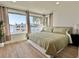 Bright main bedroom featuring a large window with water views and wood laminate flooring at 320 Palm Ne Is, Clearwater Beach, FL 33767