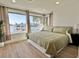 Bright main bedroom featuring a large window with water views and wood laminate flooring at 320 Palm Ne Is, Clearwater Beach, FL 33767