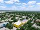 Aerial view of a residential area with lush trees and buildings nearby a body of water at 3811 N Oak Dr # E62, Tampa, FL 33611