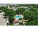 This is an aerial view of the community pool with lush landscaping and nearby condos at 3811 N Oak Dr # E62, Tampa, FL 33611