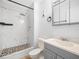 Bathroom featuring tiled shower with glass door and updated vanity at 3811 N Oak Dr # E62, Tampa, FL 33611