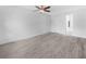 The bedroom has wood-look floors, a ceiling fan and en suite bathroom at 3811 N Oak Dr # E62, Tampa, FL 33611