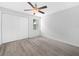This bedroom features wood-look floors, a ceiling fan and a double closet at 3811 N Oak Dr # E62, Tampa, FL 33611