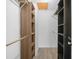 This is a well-organized walk-in closet with built-in shelving and wooden rods at 3811 N Oak Dr # E62, Tampa, FL 33611