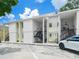 Two-story condominium building with parking in front and stairs leading to upper units at 3811 N Oak Dr # E62, Tampa, FL 33611