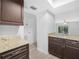 This is a kitchen with granite counters, stainless steel appliances, and dark wood cabinets at 3811 N Oak Dr # E62, Tampa, FL 33611
