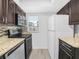 This is a modern kitchen with stainless steel appliances, granite counters, and dark wood cabinets at 3811 N Oak Dr # E62, Tampa, FL 33611