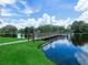 This is a picturesque view of the pond with a walking path and blue skies at 3811 N Oak Dr # E62, Tampa, FL 33611