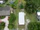 This aerial view showcases the home's setting amidst mature trees and a well-maintained lawn at 702 Hillsboro St, Plant City, FL 33563