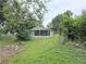 Large backyard featuring a screened patio and ample space for outdoor activities at 702 Hillsboro St, Plant City, FL 33563