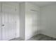Bright bedroom with closet and two doors, and modern wood-look flooring at 702 Hillsboro St, Plant City, FL 33563