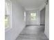 Bright hallway with fresh white walls and attractive gray wood-look flooring at 702 Hillsboro St, Plant City, FL 33563