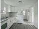 A well-lit kitchen with white cabinets, granite countertops, and stainless steel appliances at 702 Hillsboro St, Plant City, FL 33563