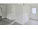 Living room featuring white walls, wood-look flooring, and a door at 702 Hillsboro St, Plant City, FL 33563