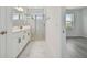 Elegant bathroom featuring a walk-in glass shower, dual sink vanity, and modern fixtures at 17810 Cherished Loop, Bradenton, FL 34211