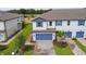 Two-story townhome with blue garage doors and brick driveway at 5657 Tripoli Dr, Palmetto, FL 34221