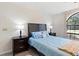 Bright bedroom with a queen-size bed and large window at 13473 Bruni Dr, Spring Hill, FL 34609