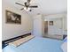 Spacious bedroom with ceiling fan and access to bathroom at 13473 Bruni Dr, Spring Hill, FL 34609