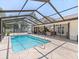 Inviting pool area with covered patio and spacious deck at 13473 Bruni Dr, Spring Hill, FL 34609