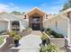 Grand home entrance with landscaping and walkway at 13473 Bruni Dr, Spring Hill, FL 34609