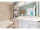 Stylish bathroom features double sinks, neutral color palette, modern vanity, and tub with tile surround at 18039 Cherished Loop, Bradenton, FL 34211