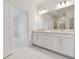Double vanity bathroom with quartz countertop and large mirror at 18039 Cherished Loop, Bradenton, FL 34211